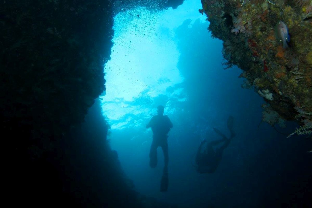 Cliff edge above the Blue Hole, Tablas Island — showing the scale of the jump and the deep pool below